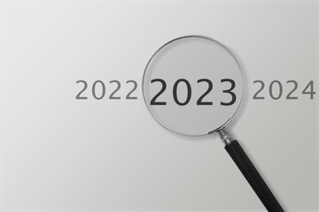 Magnifier glass with 2023 numbers on background