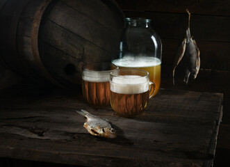 Still life with beer and fish on a wooden background. Rustic style.