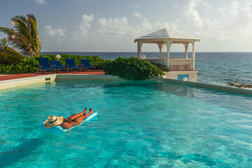 woman in pool in tropical resort