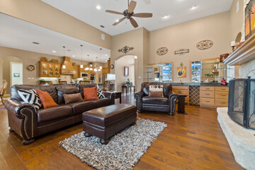 a farmhouse living room with a stone fireplace