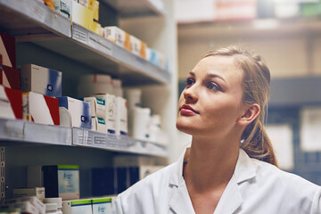 Its my true calling to work as a pharmacist. Shot of an attractive young woman working in a pharmacy.