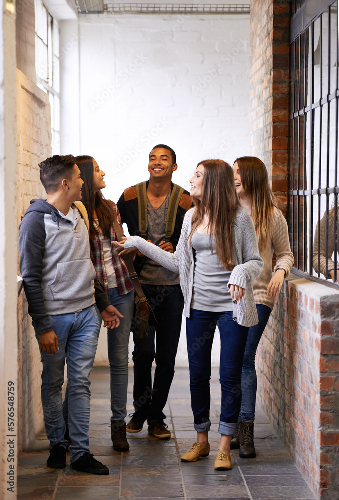 Poster loving life on campus. full length shot of a group of university students socializing on campus.