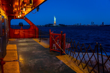 View of the Statue of :Liberty and New Jersey from the Staten Island Ferry at Night