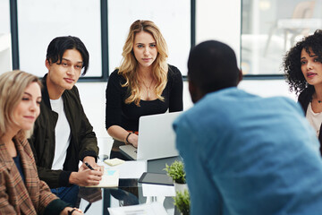 Productivity is priority in their meetings. Shot of a group of colleagues having a brainstorming...