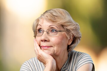 Beautiful senior old woman posing in park