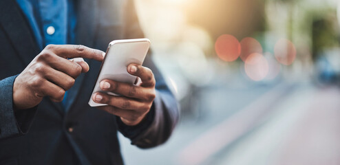 Making business connections throughout the city. Closeup shot of an unrecognizable businessman using a cellphone in the city.