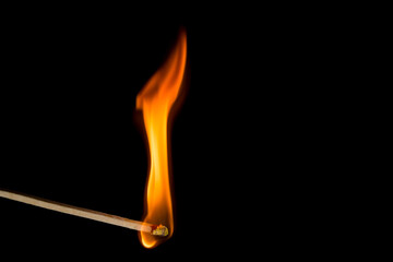 burning match on black background