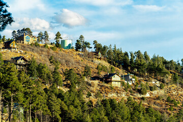 Houses on ridge in the mountains of arizona with log cabin and traditional design in forestry area or rural suburbs