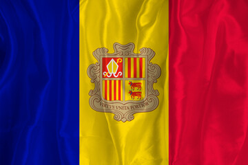 The Andorran flag on a silk background is a great national symbol. Fabric texture The official...