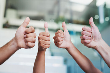 100 approved. Cropped shot of a group of hands showing thumbs up in an office.