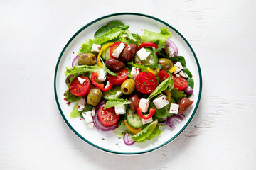 Greek village salad horiatiki with feta cheese, olives, cherry tomato, cucumber and red onion, vegeterian mediterranean food, low calories dieting meal.
