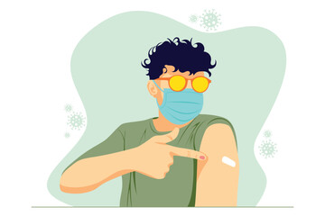 A young man wearing sunglasses and wearing a face mask shows where the vaccine has been applied
