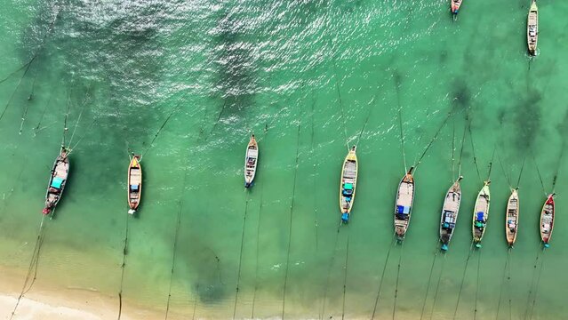 Aerial View of Thai traditional longtail fishing boats in the tropical sea beautiful beach in phuket thailand	