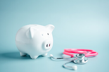 Piggy bank with stethoscope. money health check concept. Health care financial checkup and saving...