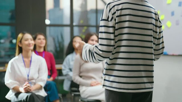 The female businesswoman is seen conversing with her team in a contemporary office setting, passionately describing her work at meeting room.