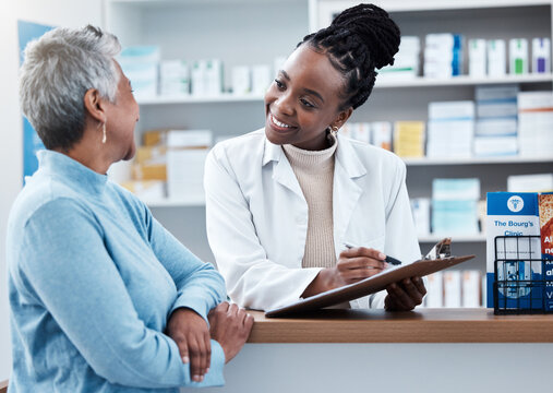 Pharmacy, healthcare or insurance with a customer and black woman pharmacist in a dispensary. Medical, clipboard and trust with a female medicine professional helping a patient in a drugstore