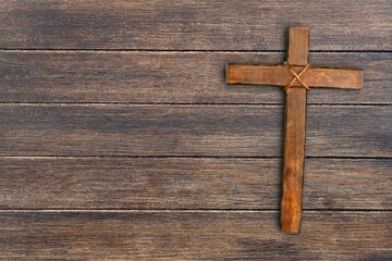Wooden christian cross on stone desk
