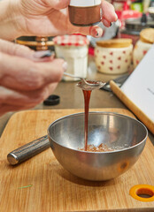 Chef prepares pie syrup in a metal bowl in the kitchen
