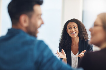 She helped rescue their relationship. Shot of a young therapist speaking to a couple during a counseling session and looking pleased.