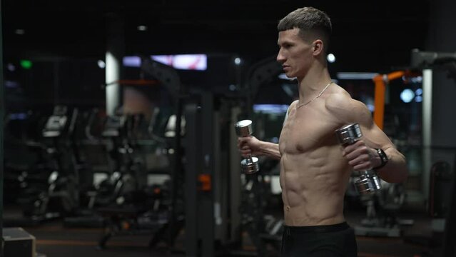 muscular sportsman training in sport gym with barbell. sport sportsman with barbell in gym.