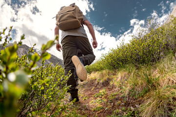 Closeup photo of walking hiker legs on the mountain trail