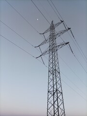 high voltage power line, power pole, moon in the background 