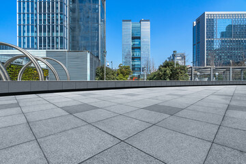 modern glass building exterior with empty pavemen