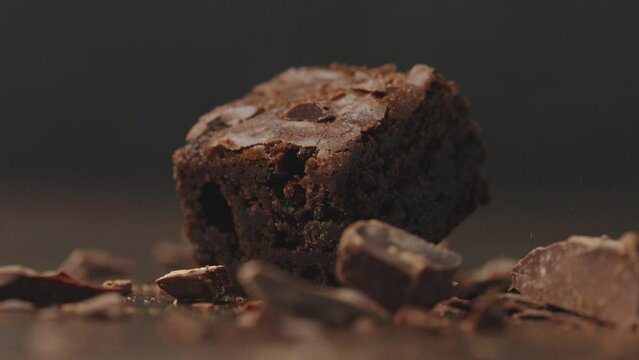 close up of chocolate muffin.chocolate brownie.filling chocolate piece.slow motion drop.sweet food.chocolate tasty baking,baked homemade delicious cocoa 
