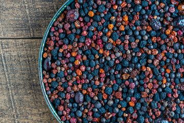 Homemade dried wild berries in background, closeup, top view. Food background. Healthy food, mix of colorful dry berry