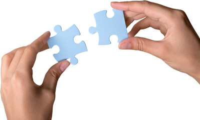 Closeup on Hands Combining Puzzle Pieces Together