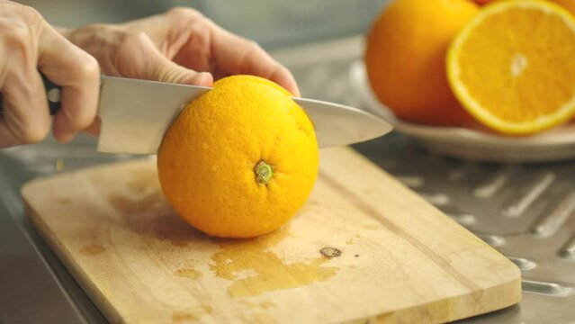slicing orange on kitchen board,
orange juice,tropical healthy orange,vitamin food,ripe orange