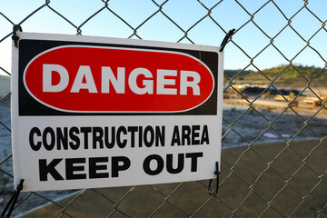 Danger sign on chain linked fence for construction area