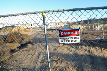 Danger sign on chain linked fence for construction area