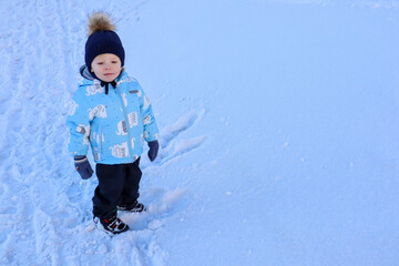 little child enjoy playing in snow