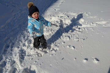 little child enjoy playing in snow