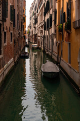 A canal in venice with a bridge and a boat on it
