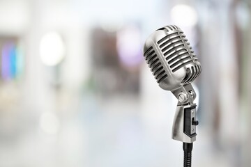 Classic retro steel microphone on office background