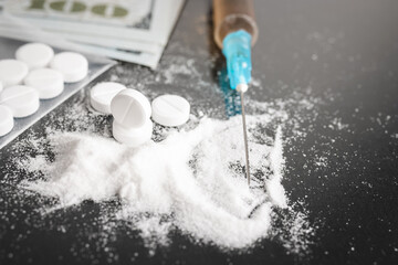 White pills, drugs or medical treatment, cocaine or heroin white powder, syringe with a dose and us...