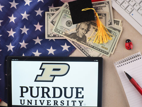 In this photo illustration, Purdue University  logo seen displayed on a tablet.