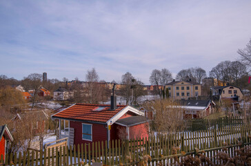 Allotment gardening houses and skyscraper apartment buildings an early spring sunny day in Stockholm