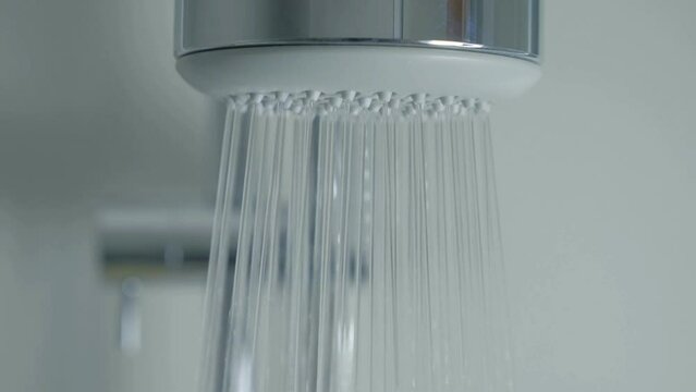 Close up Modern Shower Head with Water splashing. Taking shower bathroom cleaning hygiene habits.