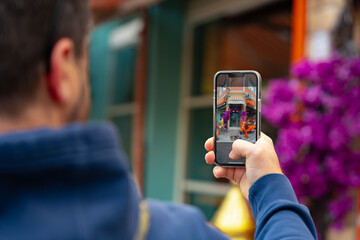 Man tourist is taking photo on his phone in Istanbul