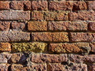 Horizontal brick textured wall background in design loft style. Grunge reddish brown colored with copy space. Blank poster or wallpaper surface template. Partly damaged pattern.