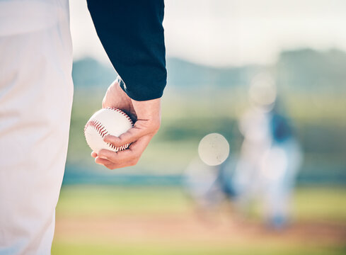 Baseball player, ball and athlete or pitcher hand in a competitive match or game on the sports field for training. Closeup, sportsman and person playing a sport or softball as exercise and fitness