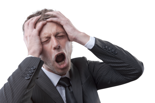 Desperate businessman with head in hands