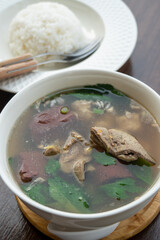 Pork blood tofu soup with gourd leaves,Clear soup asian style food mixed minced pork balls,
Pork blood cubes and liver in with bowl,Healthy and Rich in iron and protein