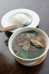 Pork blood tofu soup with gourd leaves,Clear soup asian style food mixed minced pork balls,
Pork blood cubes and liver in with bowl,Healthy and Rich in iron and protein