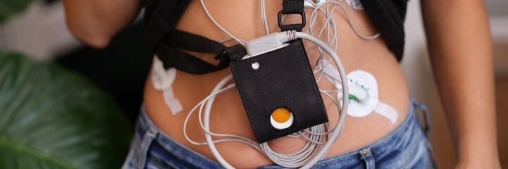 24-hour ECG monitoring and Holter monitoring on a woman body