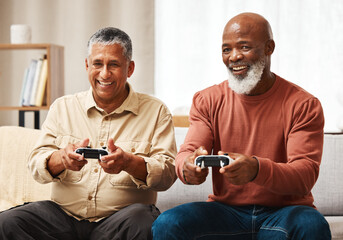 Gaming, funny and senior black man friends playing a video game together in the living room of a home. Sofa, fun or retirement with a mature male gamer and friend enjoying a house visit to game