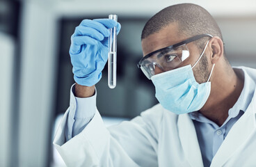 The mysteries of the physical and chemical world intrigue me. Shot of a young scientist conducting...